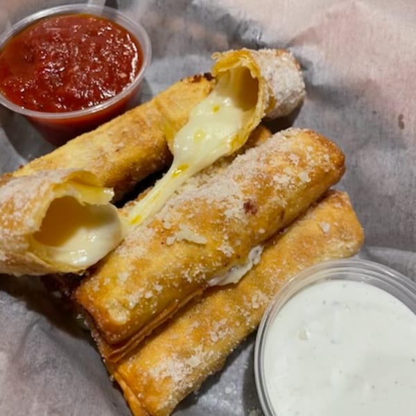Golden-brown fried mozzarella sticks with melted cheese oozing out, served with marinara and ranch.
